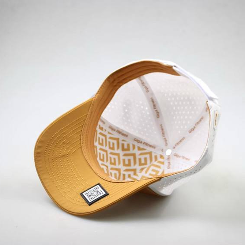 Yellow and white cap with a geometric pattern on a light gray background