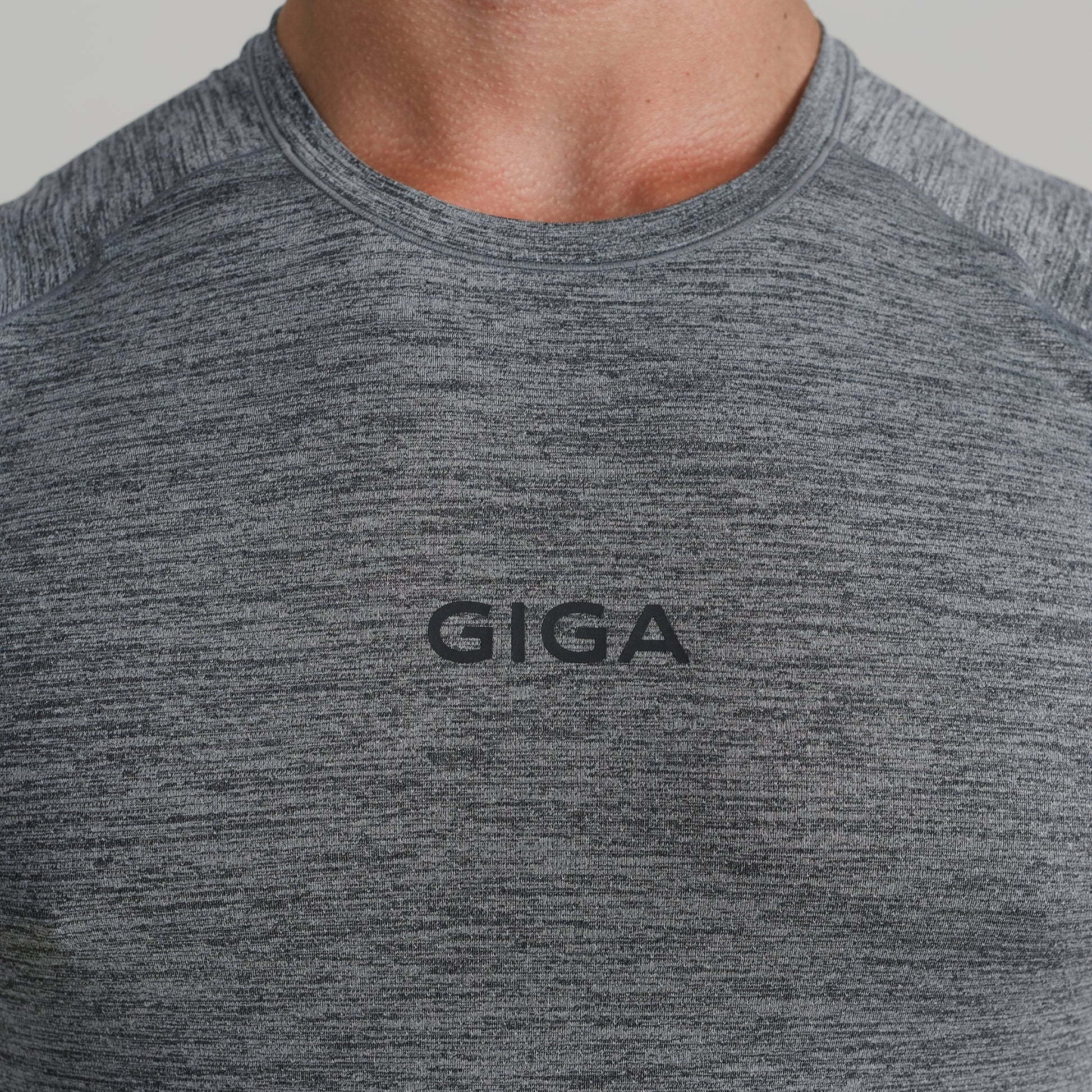 Close-up of GIGA logo on grey Base Tee chest