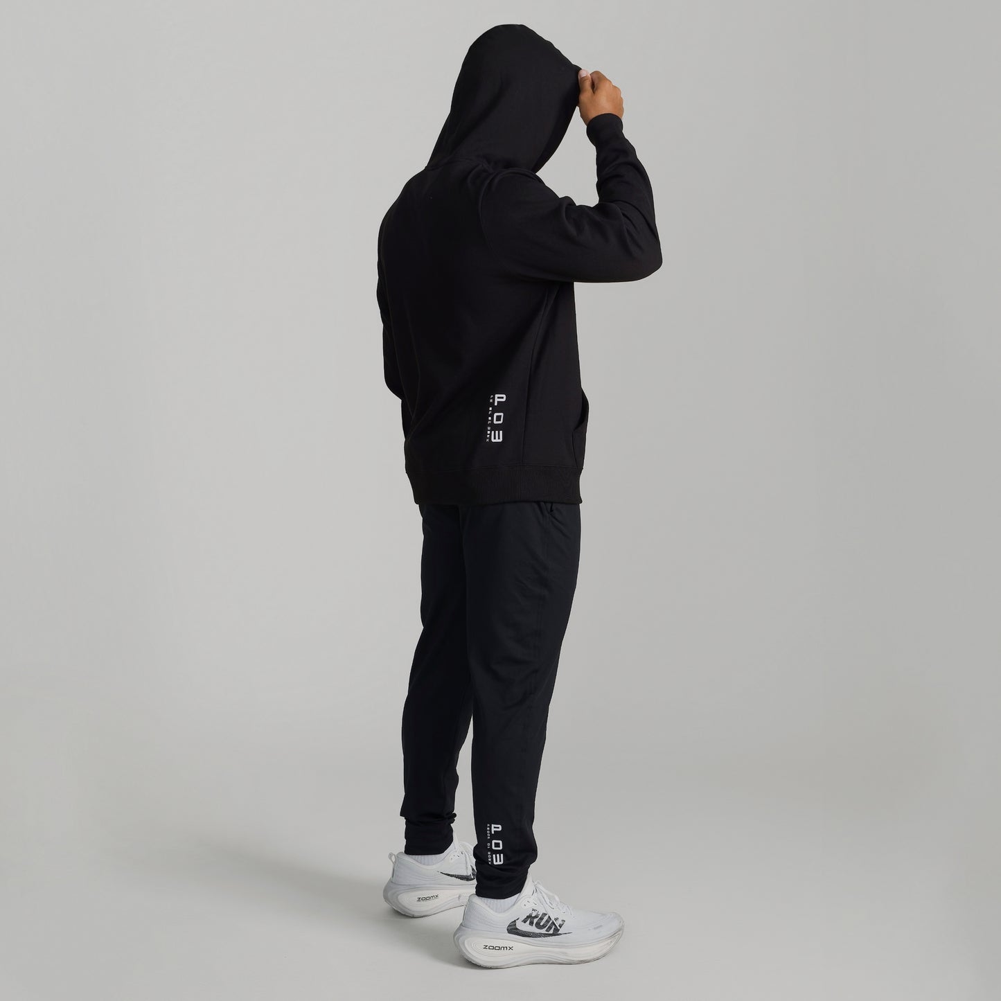 Man wearing GIGA Recovery Hoodie in black back view full body