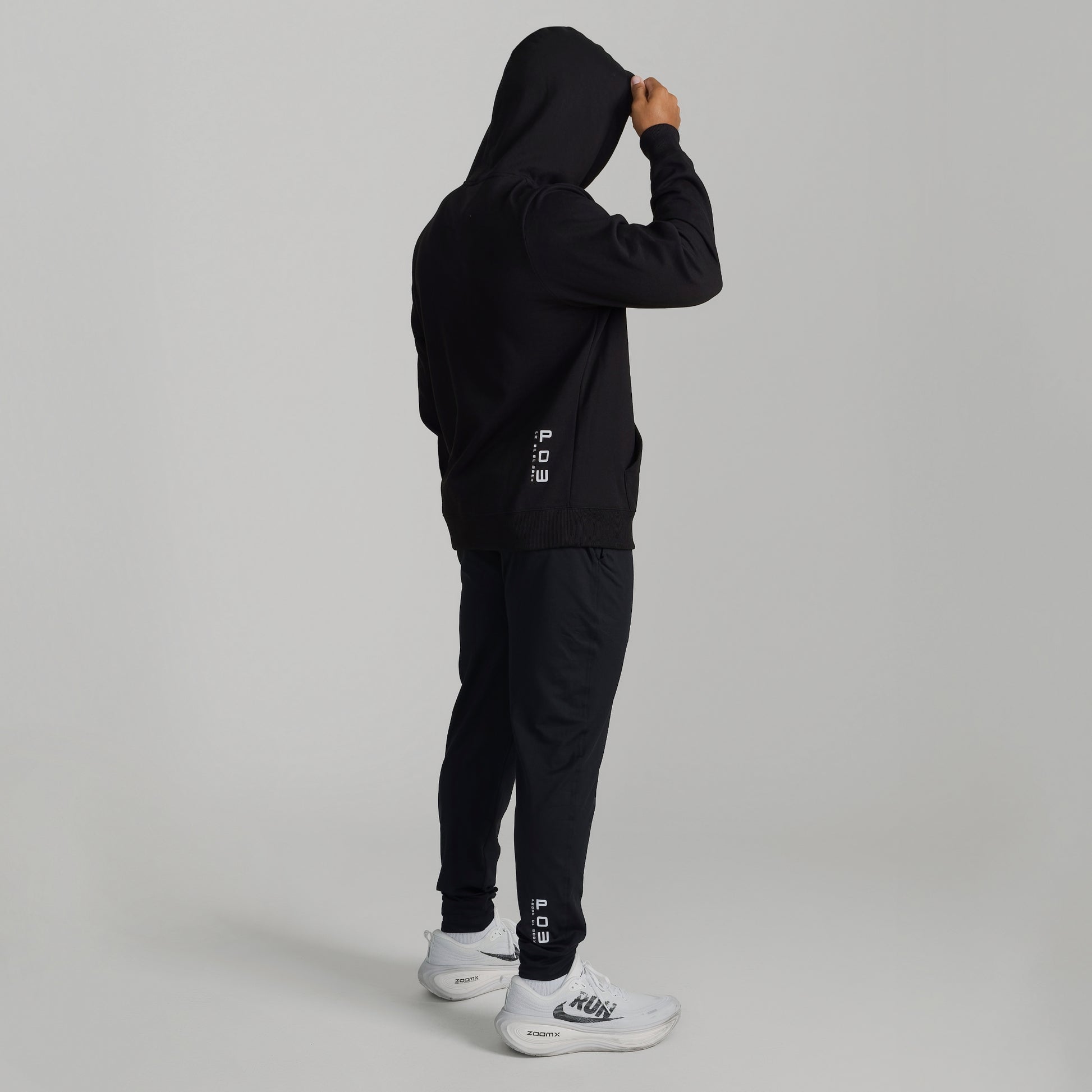 Man wearing GIGA Recovery Hoodie in black back view full body
