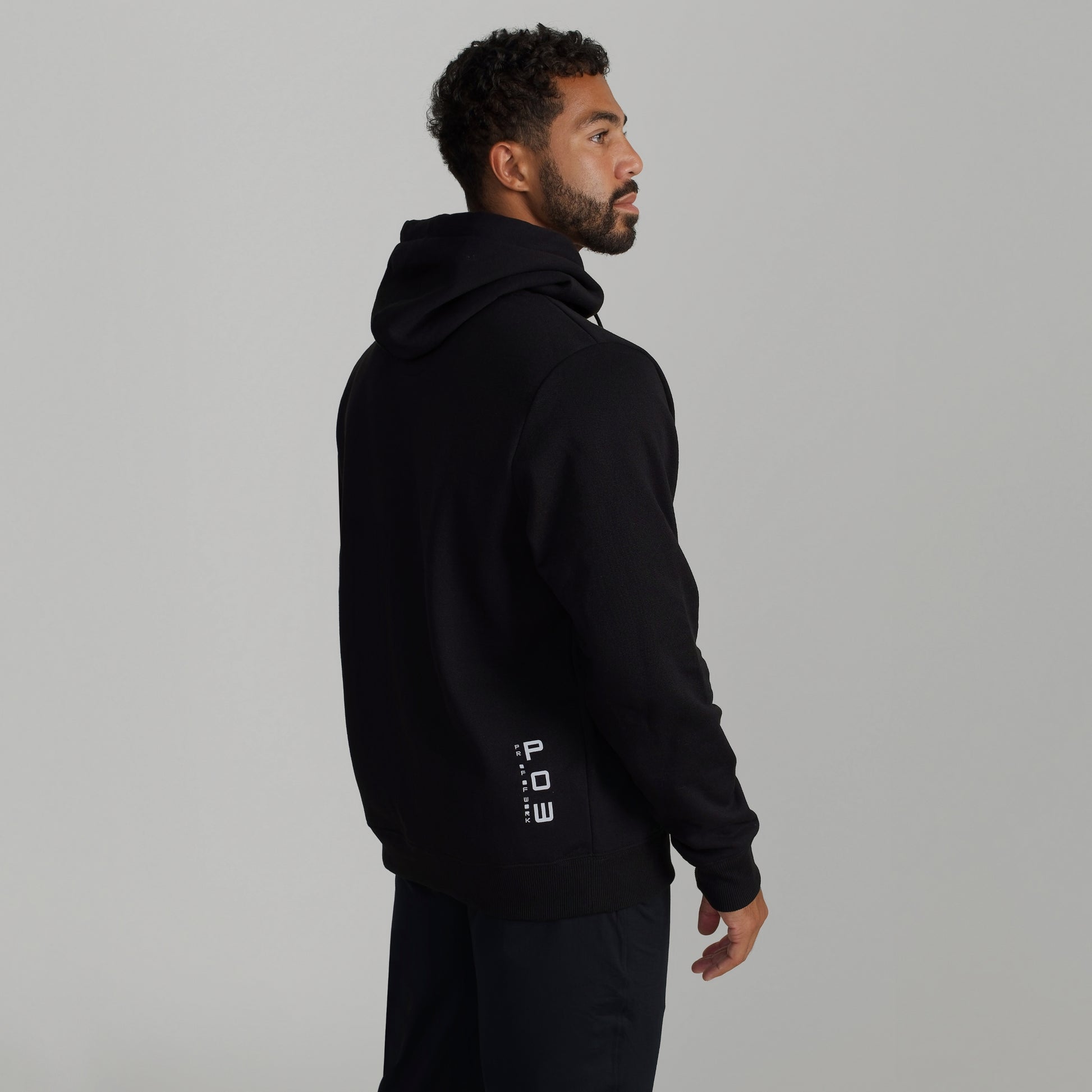 Man wearing GIGA Recovery Hoodie in black back three quarter view