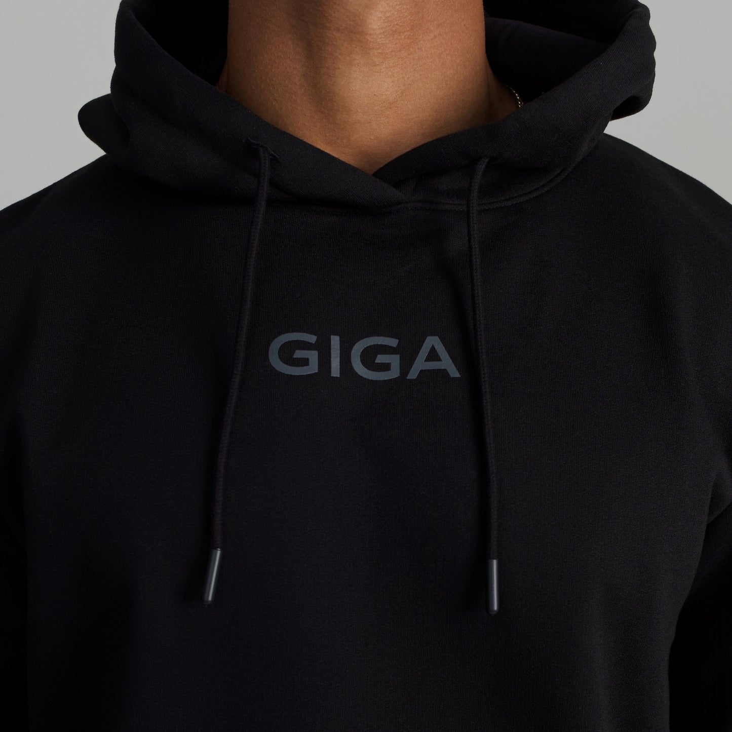 GIGA Recovery Hoodie in black chest logo and drawstring detail